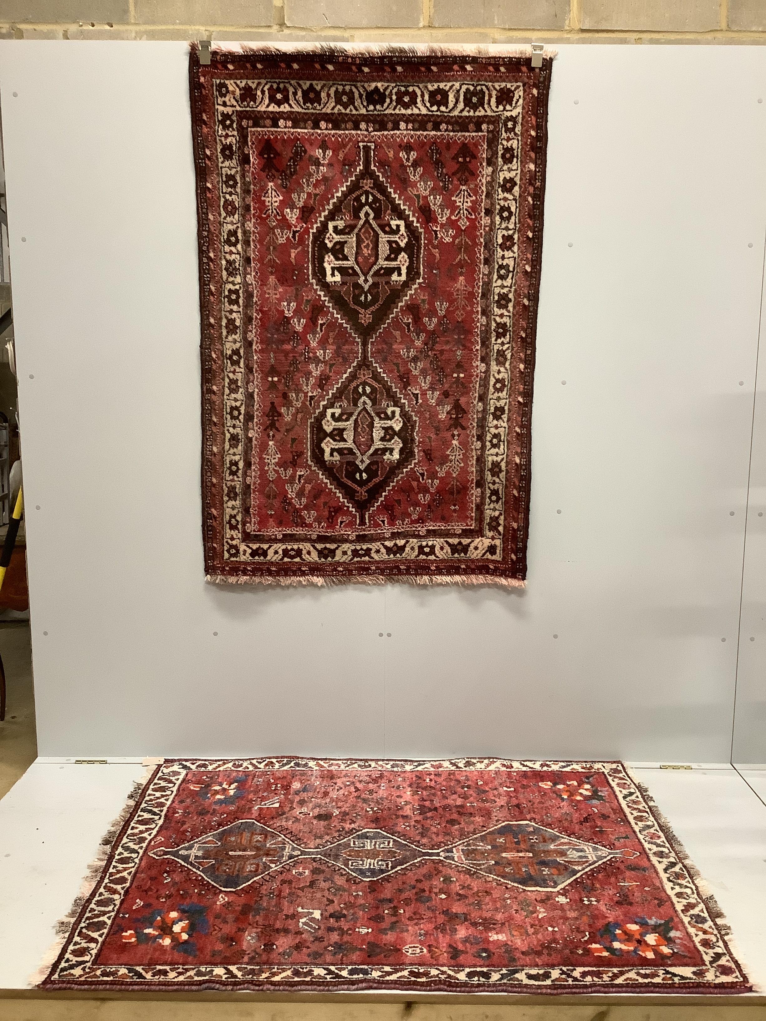 Two Caucasian style red ground rugs, larger 165 x 111cm